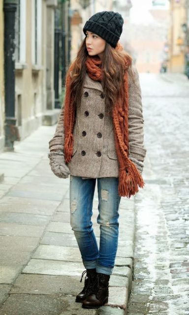 With double-breasted coat, cuffed jeans, mid calf boots and beanie