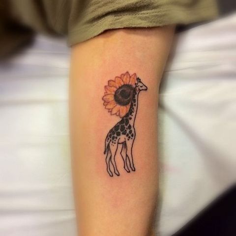 Giraffe with sunflower tattoo