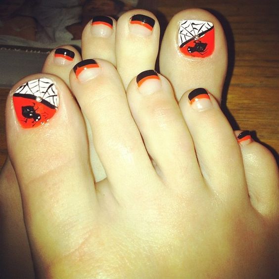 Picture Of striped orange and black nails and accent nails ...