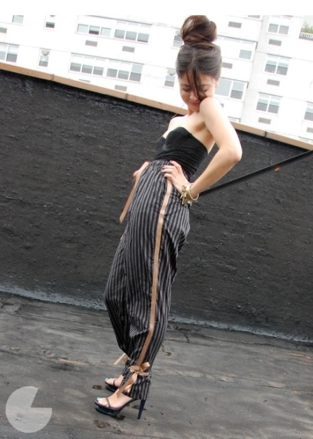 a party look with a strapless black top, black side-striped pants, black platform shoes