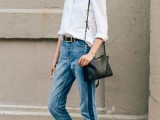 a white shirt, blue side-striped jeans, black birkenstocks and a black bag for a casual outfit