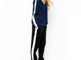 a casual outfit with a navy striped sleeve sweatshirt, black side-striped pants, white heels