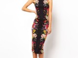 a bright floral fitting midi dress with no sleeves and black heels for a statement work outfit