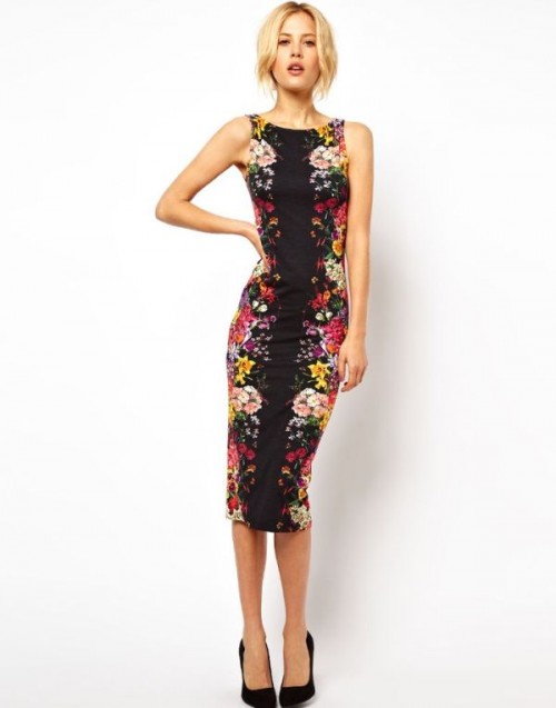 a bright floral fitting midi dress with no sleeves and black heels for a statement work outfit