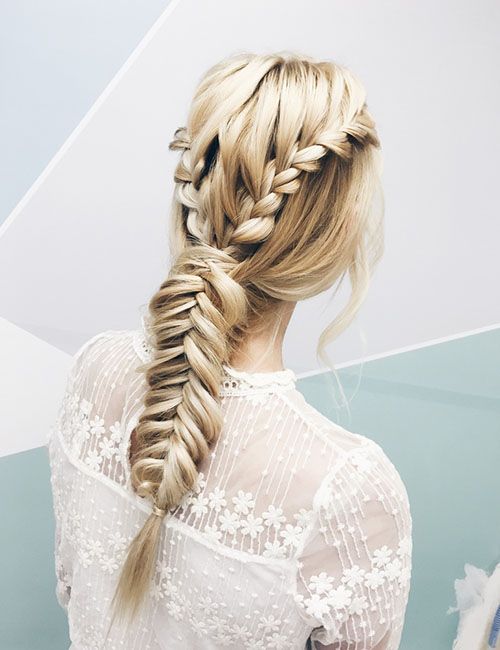 a boho hairstyle with a volumetric top, side braids and a loose fishtail braid is a cool and catchy idea