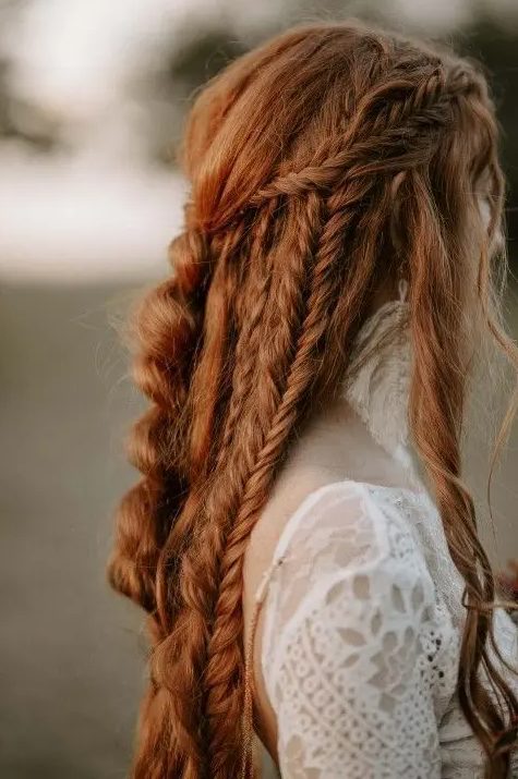 a bold boho ginger hairstyle with braids all over and a bump on top is a lovely idea for a boho bride