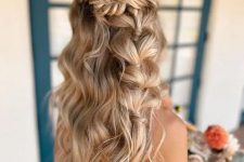 a creative boho wedding half updo with a fishtail braid halo and a bubble braid and waves down is amazing