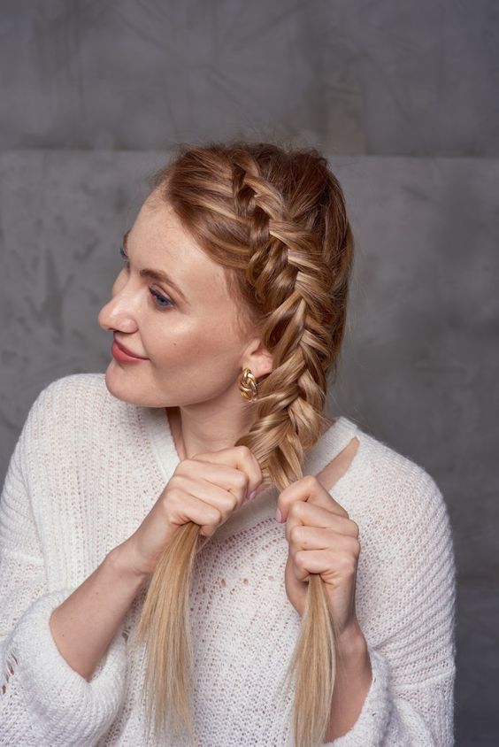 a fishtail braid with a part on top and on the side is a cool and catchy idea for a boho look