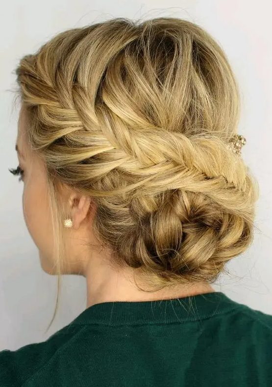 a fishtail side braided updo with a braided bun and some locks down