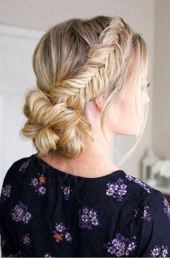 a low bun with two fishtail side braids and a bump is a chic and comfy to wear option