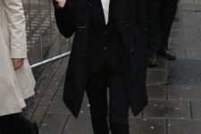 a monochromatic outfit with a white tee, a black waistcoat and skinnies, a duffy coat and brown boots