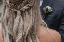 a wavy half updo with braids and a tiny embellished hairpiece is a very dreamy and chic idea