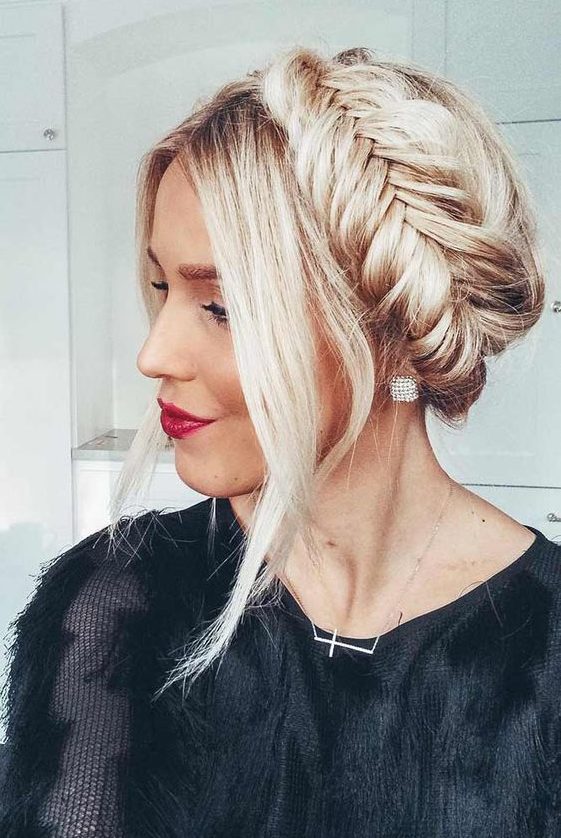An updo with a pretty fishtail braid halo and face framing locks is a cool and bold idea for the ohlidays if you have long hair