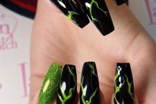 bold and cool black and neon green nails and neon green glitter accents for Halloween