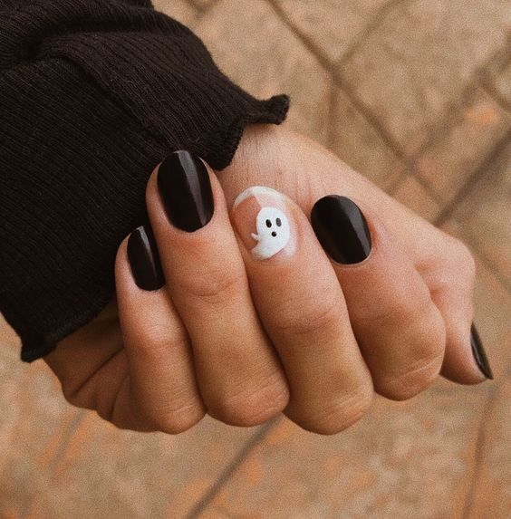 glossy black nails and a nude accent one with a ghost for Halloween, this is classics