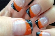 nude nails with orange and black glitter curves are ideal for Halloween, nothing excessive here