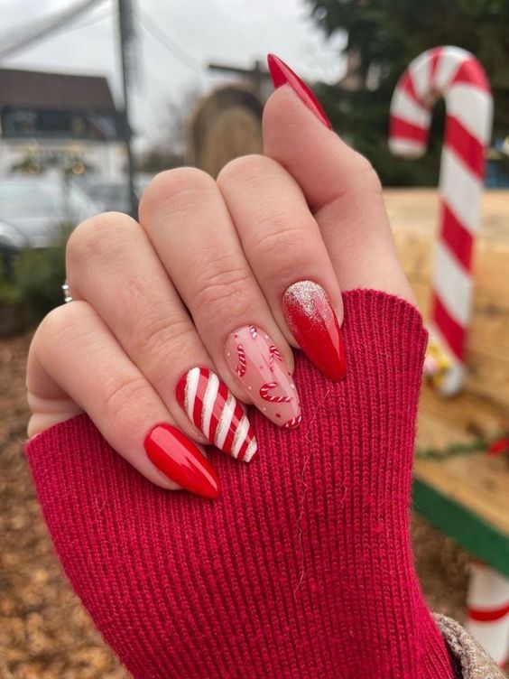 a bold Christmas manicure with red, white and gold glitter nails and a candy cane one is a pure fun for the holidays