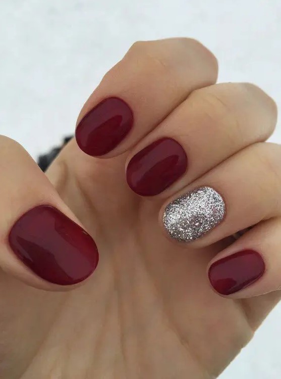 a classic red manicure spruced up with a silver glitter accent nail is perfect for Christmas