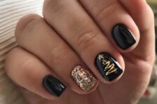 a cool NYE party manicure with black glossy nails and a gold sequin one plus a gold tree accent nail is fun and bold