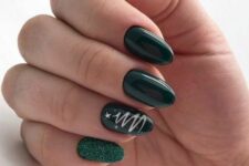 a dark green Christmas manicure with glossy and glitter nails and a Christmas tree swirl is amazing