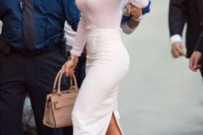 a fitting outfit with a blush fitting long sleeve top, a creamy midi pencil skirt and creamy shoes plus a tan bag