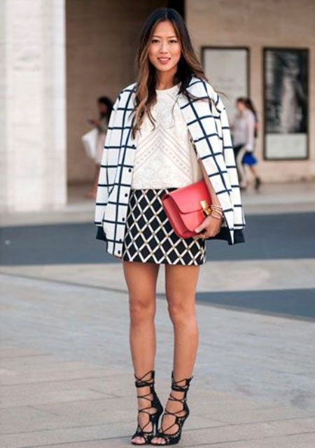 a monochromatic work look with an assortment of prints, a red bag and black lace up shoes that highlight your legs even more