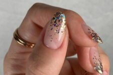 a nude manicure with colorful sparkles is a lovely idea for NYE parties, it will add a bit of color to your look