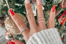 a red Christmas manicure with a snowflake and stripe nail is a classic idea for Christmas