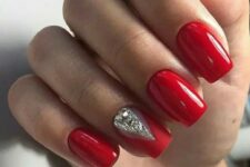 bold red nails with a geometric rhinestone touch for a winter holiday party
