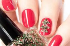 bold red nails with an accent nail that shows off a green bead tree are very creative, bold and stylish for a color-loving girl