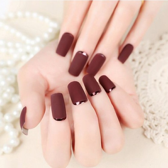 matte burgundy nails with dark copper crescent moon accents are a refined and chic idea for Christmas parties