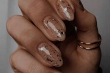 nude nails with small and large sparkles are great for NYE parties and you may keep wearing them after