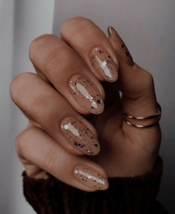 nude nails with small and large sparkles are great for NYE parties and you may keep wearing them after