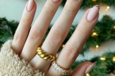 super Instagrammable Christmas nails in nude and with candy cane tips are gorgeous