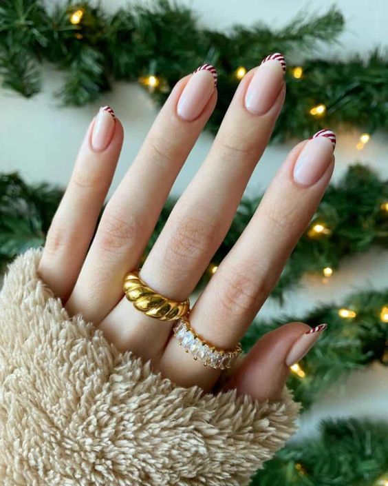 super Instagrammable Christmas nails in nude and with candy cane tips are gorgeous