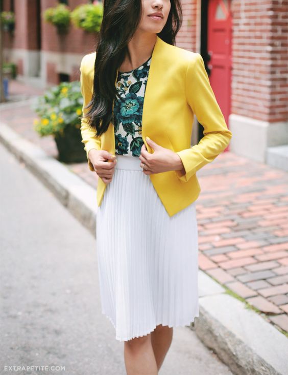 a bold work look with a green floral top, a white pleated knee skirt and a sunny yellow blazer
