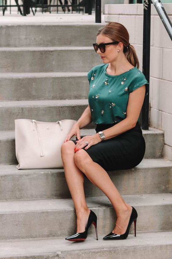 a dark green short sleeve floral top, a black pencil skirt, black heels and a creamy bag for a summer work look
