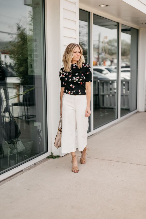 a summer work look with a dark floral top, white wideleg pants, nude lace up shoes and a tan bag