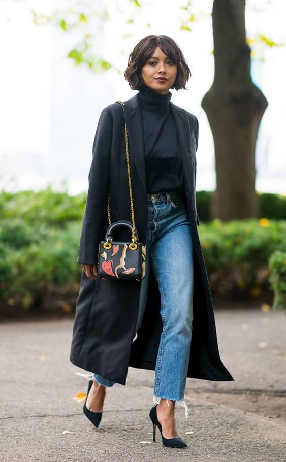 a black trench, black heels, a turtleneck and blue straight jeans for a wow spring look