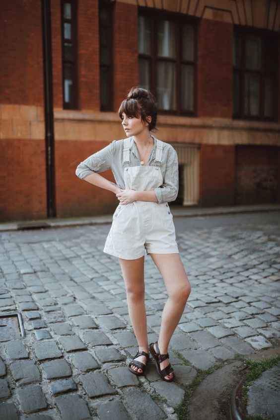 a grey shirt, a white dungaree with shorts, black sandals for a vintage summer look