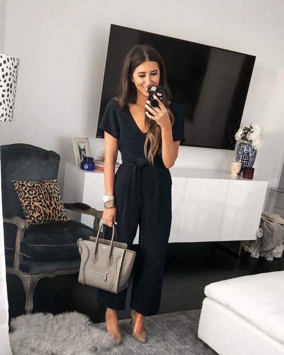 a black jumpsuit with a sasj, grey suede heels and a grey bag plus stacked bracelets