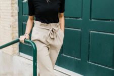 a black tee, tan paperbag pants, brown leather mules for a comfy summer work look