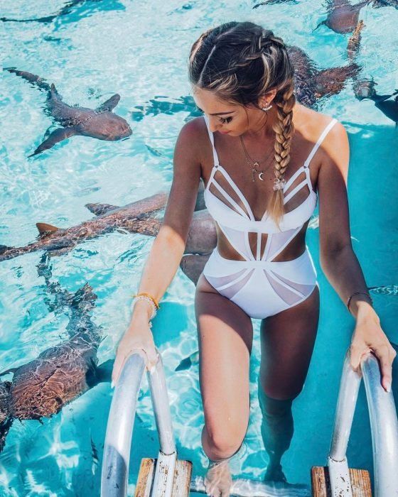 a cool white one piece swimsuit with cutouts everywhere and spaghetti straps is sexy