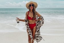 a white bikini with a high waisted bottom and a leopard print coveurp, a red lip and a hat for a bold look