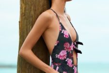 black plunging neckline swimsuit with a pink floral print and a front cutout