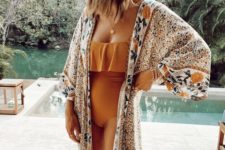 rust-colored strapless bikini and a matching floral colorful coverup for a bold boho beach look