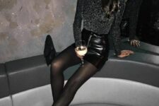 a black sequin long sleeve top, a black leather mini skirt, black tights, black booties and a clutch are all you need to shine