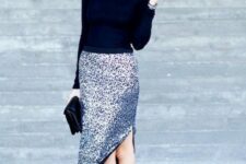 a black turtleneck, a silver sequin midi skit with a side slit, black spiked heels and a black clutch