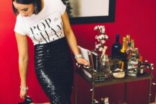 a printed t-shirt, a black sequin pencil midi skirt, black heels and statement earrings for a New Year’s Eve party