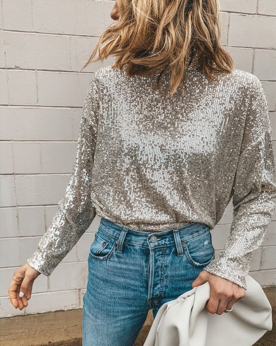 a silver sequin turtleneck with long sleeves paired with blue jeans creates a lovely holiday yet casual enough look